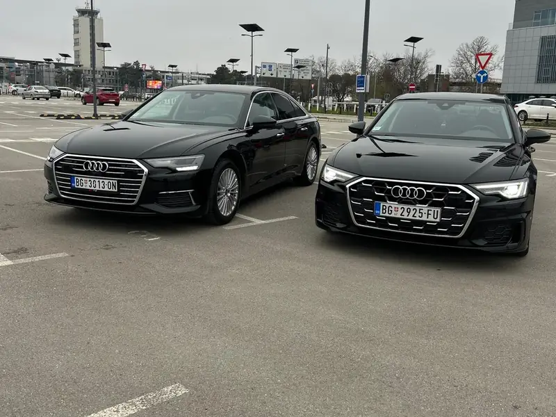 Two Passenger Transfers Audi A6s in an airport car park