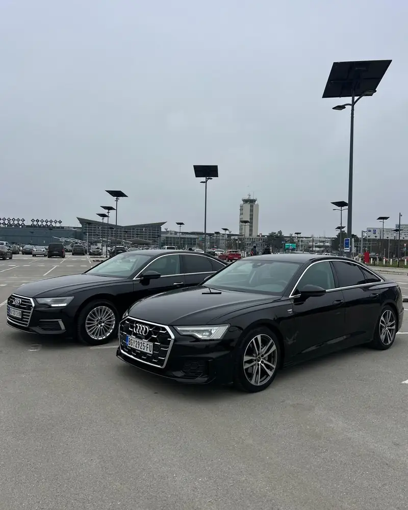 Two black Audi A6s in the Nikola Tesla Airport car park