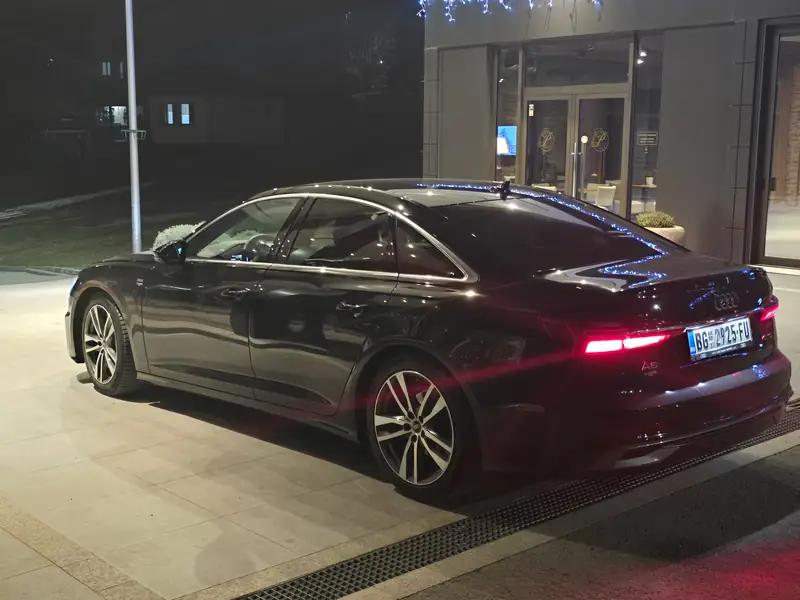 Audi A6 outside a Belgrade hotel at night
