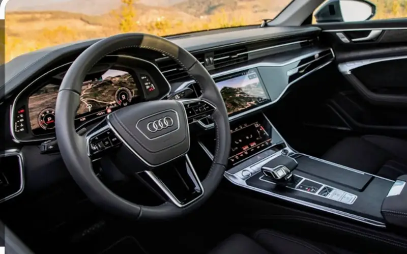 Audi A6 dashboard at night with navigation